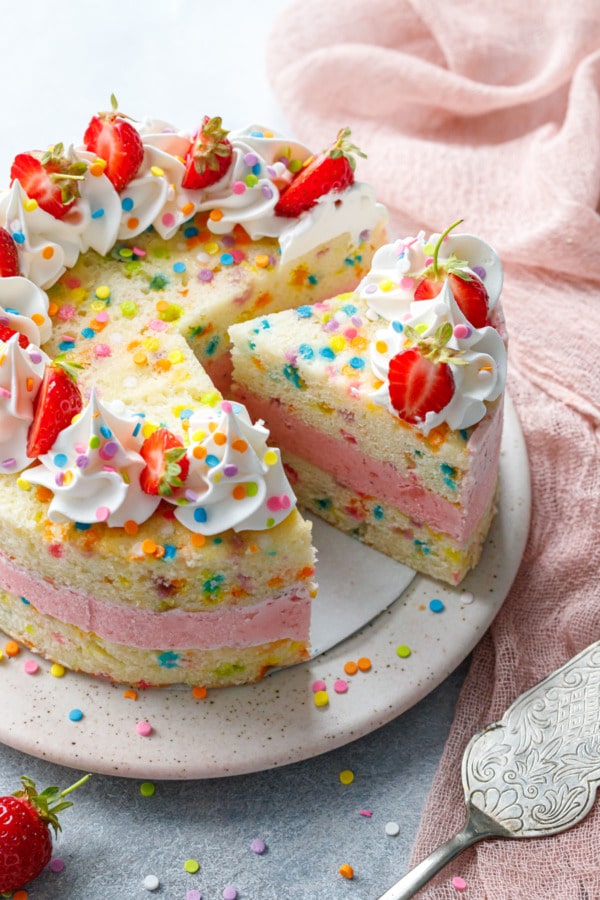 Sliced Strawberry Funfetti Ice Cream Cake with pink linen