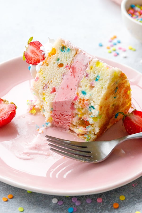 Partially eaten slice of Strawberry Funfetti Ice Cream Cake