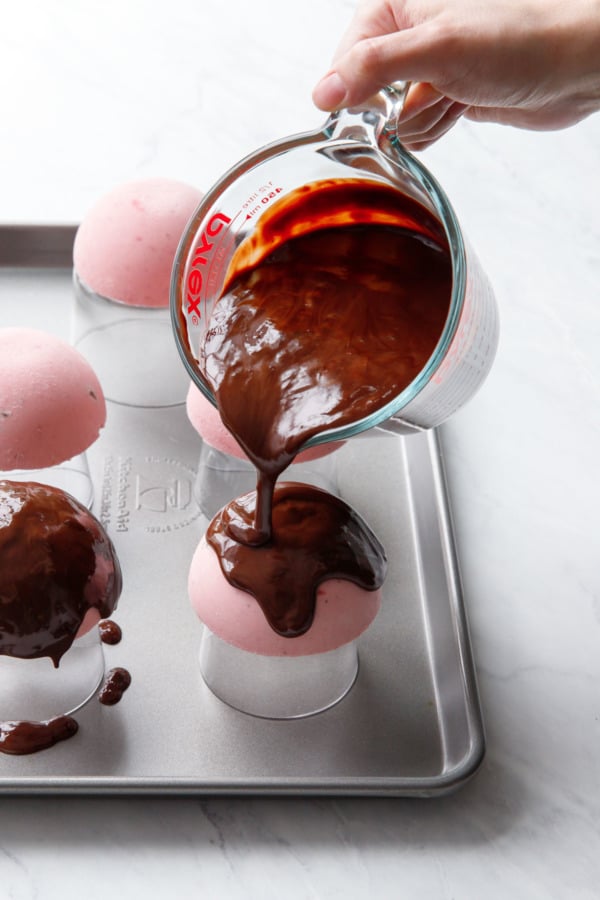 Elevate frozen cakes on small jars or glasses, then cover with the chocolate ganache glaze