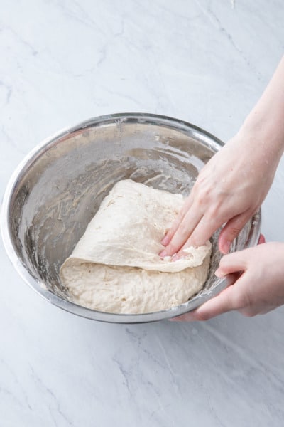 Fold the dough over itself to the other side.