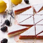 Blackberry Lavender Lemon Bars cut into triangles and dusted with sugar