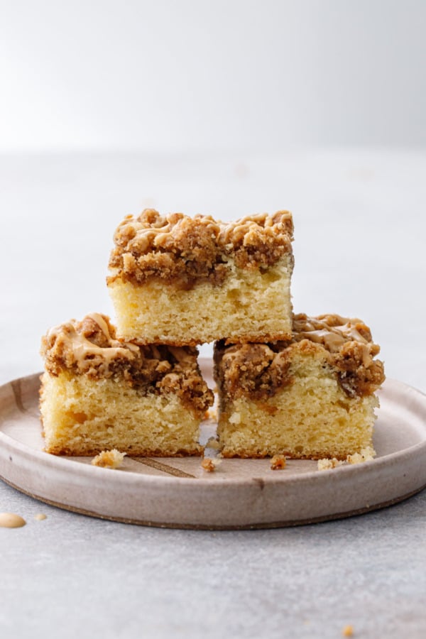 Straight on view of pyramid stack of cut coffee cake slices, showing the cake and crumb layers