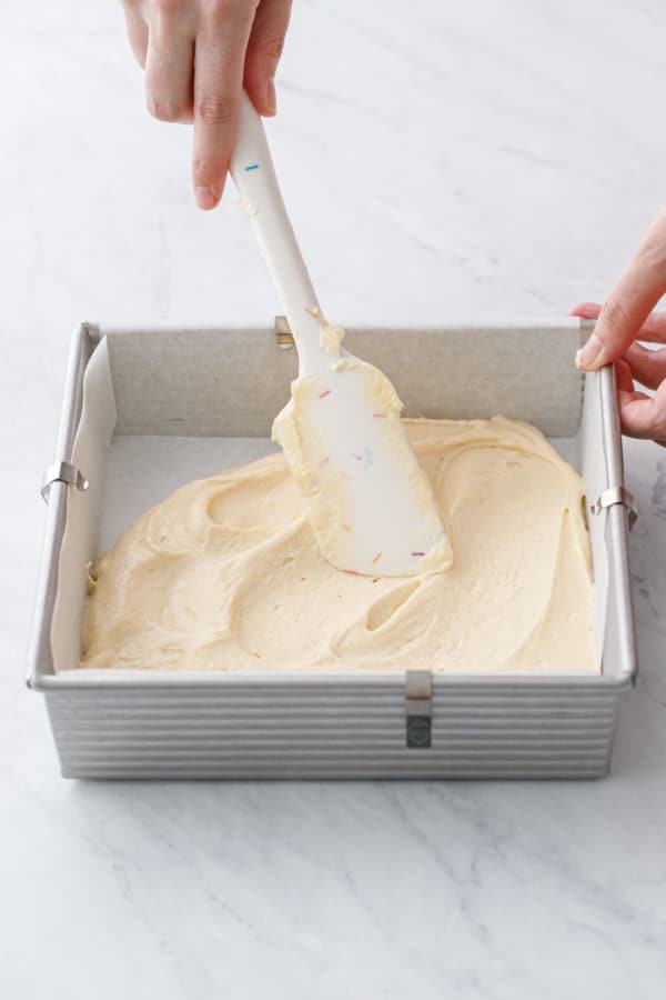 Spreading the coffee cake batter into the baking pan