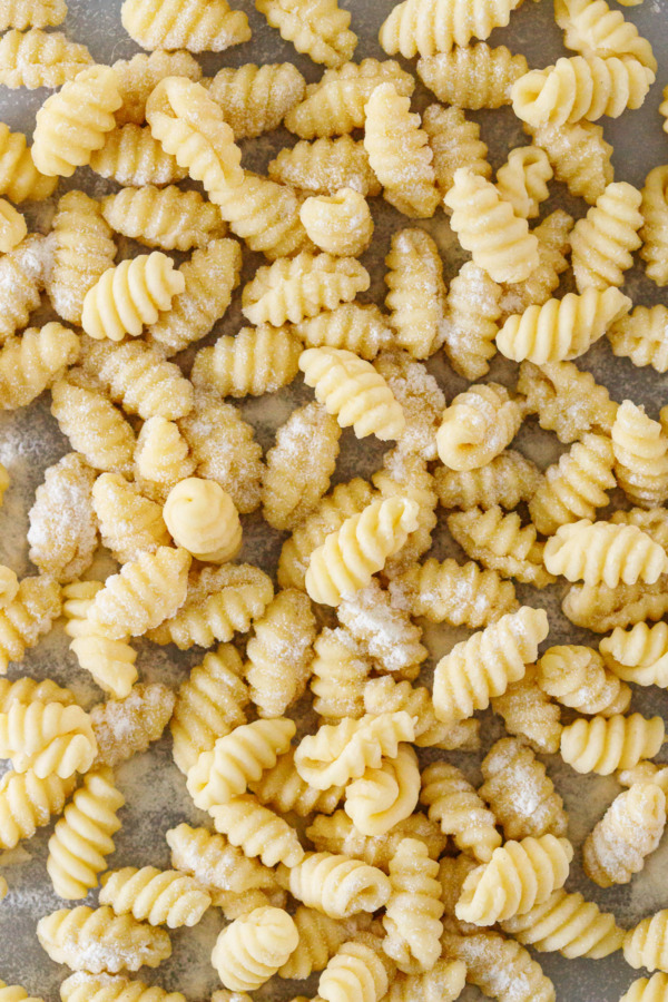 Closeup, pile of homemade gnochetti sardi pasta dusted with semolina flour