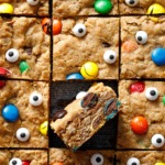 Square grid of cut Monster Cookie Bars, one tilted on its side to show cross-section