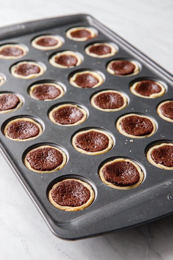 Pan of freshly baked Mini Bourbon Fudge Pies still in the muffin tin