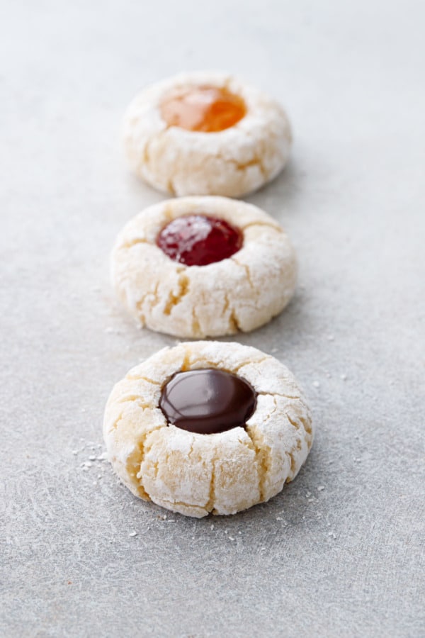 Row of Amaretto Amaretti Thumbprint cookies with three different fillings, shallow depth of field.
