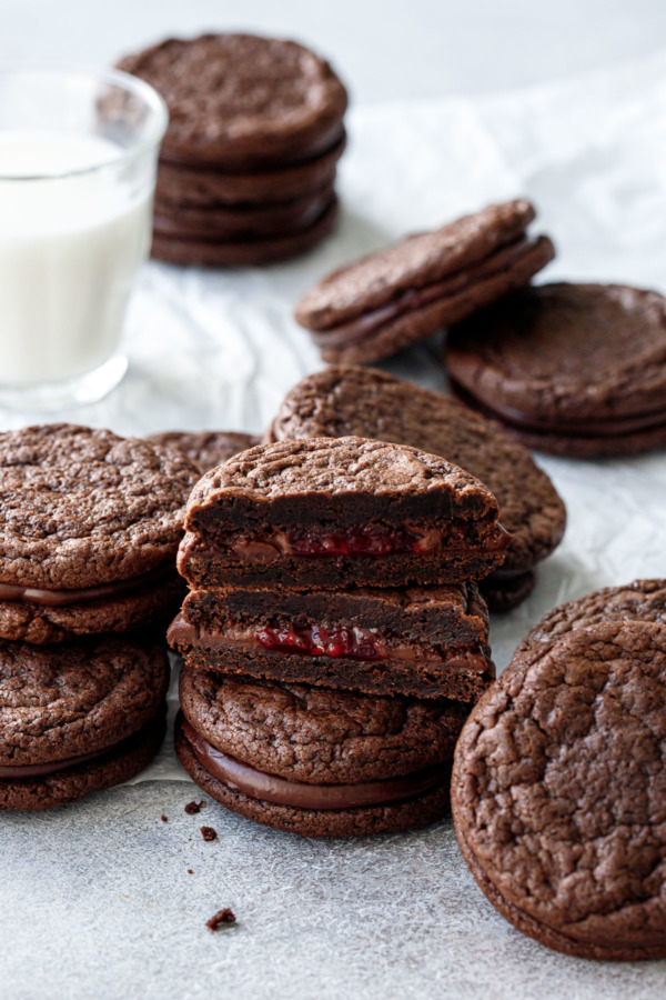 Chocolate Raspberry Sandwich Cookies, stack of cookies with one cut in half to show the fillings.