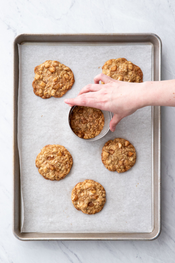 Freshly baked cookies start off unevenly shaped; swirl a round cookie cutter around to make more even circles.