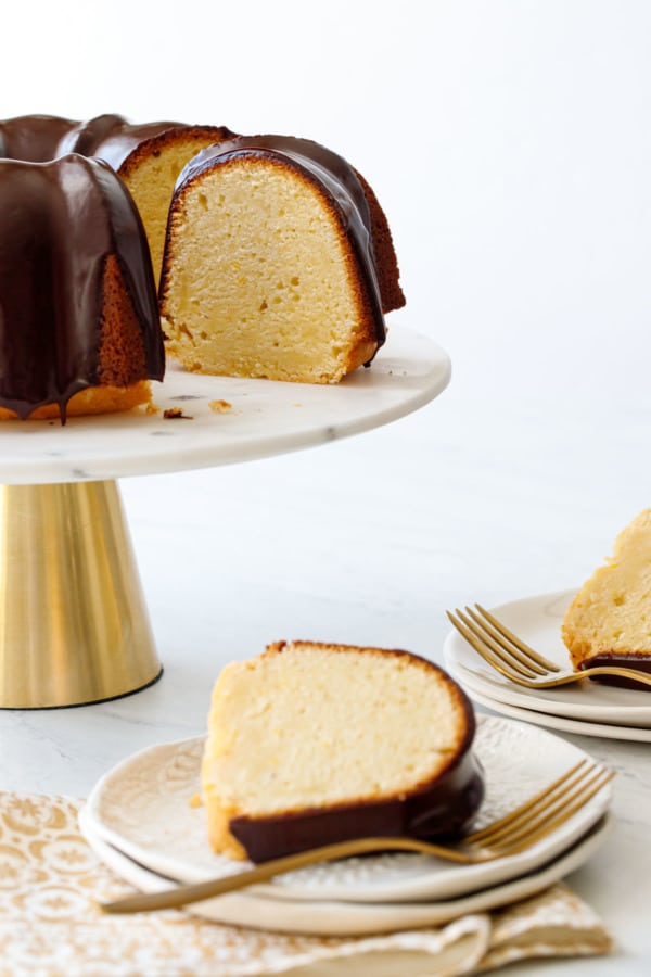 Slices of Almond Bundt Cake with Amaretto Ganache, out of focus on plates in the foreground