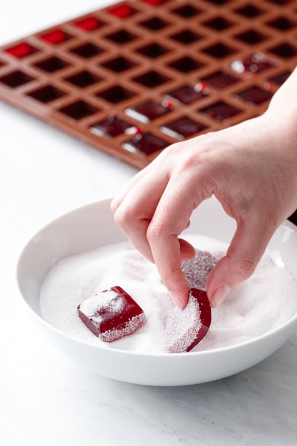 Coating the homemade gummy candies in a sour sugar mixture (sugar and citric acid).