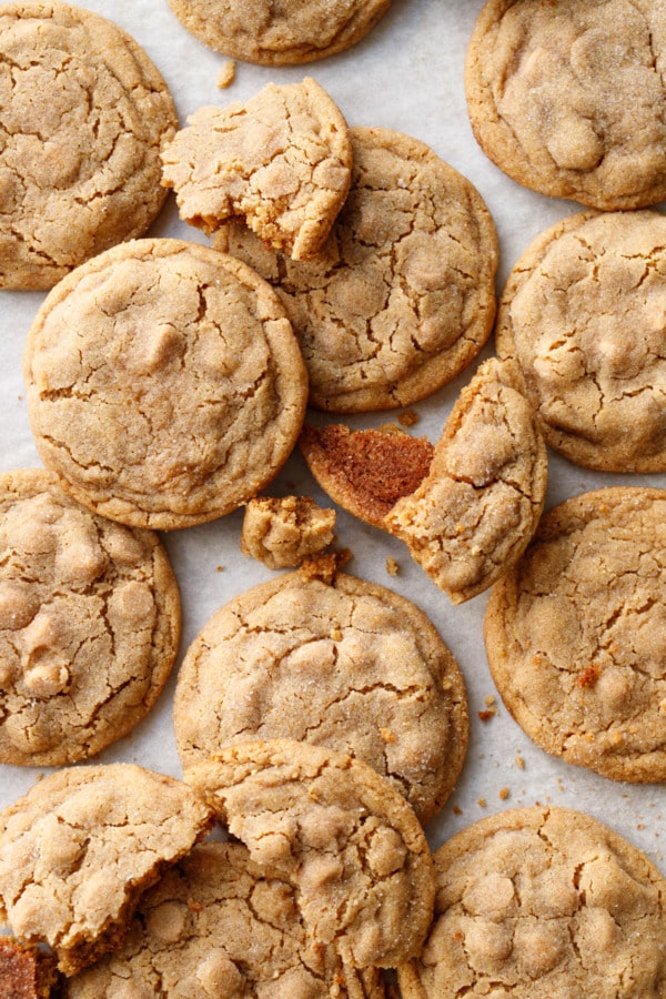 Overhead, messy Salted Peanut Butter Chip Cookies scattered about, some whole and some broken.