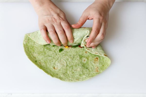 Start rolling the wrap, tucking in the sides as you go.