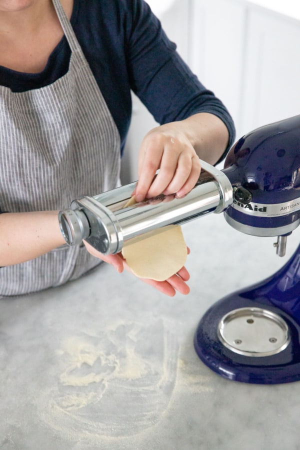 Passing the cracker dough through a pasta roller.