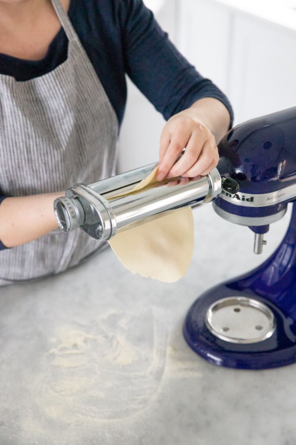 Rolling the semolina cracker dough through a pasta roller attachment.