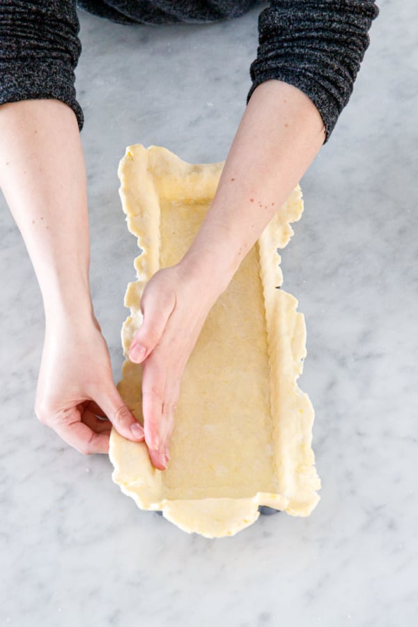 Shaping the crust into the rectangular tart pan.