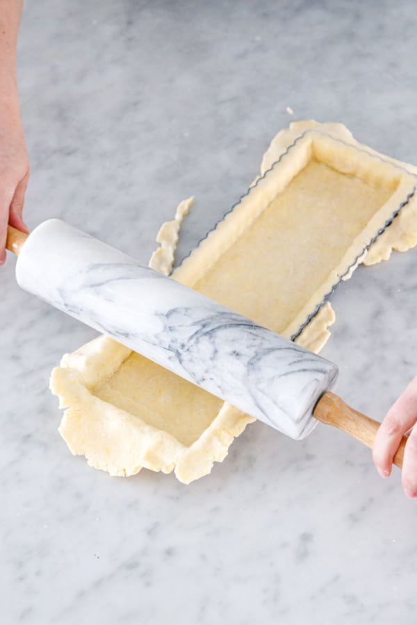Run a rolling pin over the top of the tart pan to trim off rough edges.