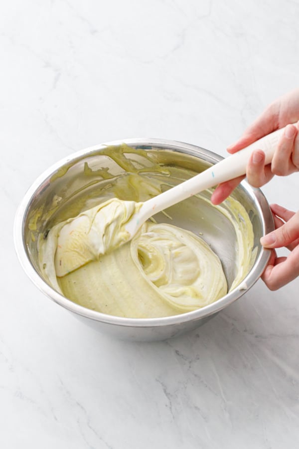 Continue folding until there are no visible white streaks remaining in the pistachio mixture.