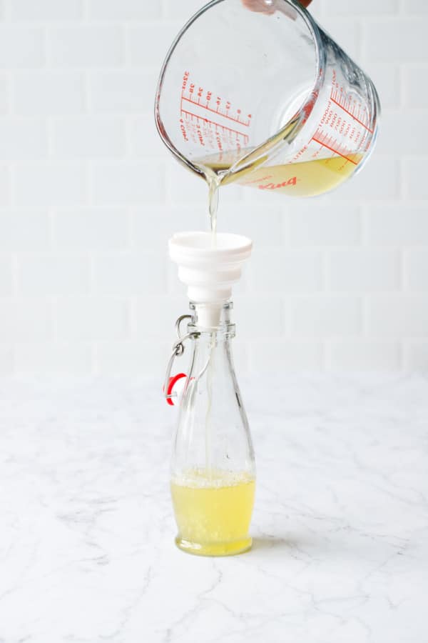 Use a funnel to transfer the homemade cordial into bottles.