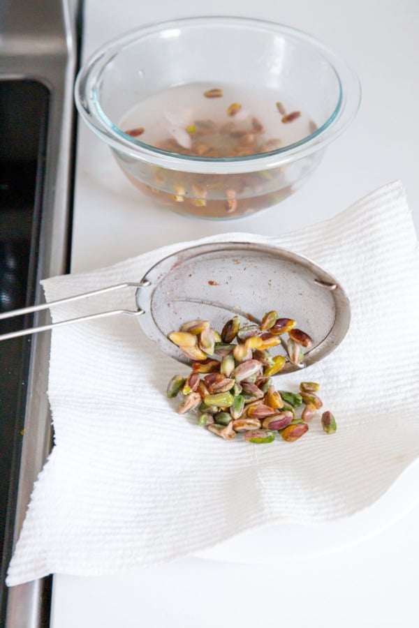 Place drained pistachios on a plate lined with a reusable paper towel or cloth.