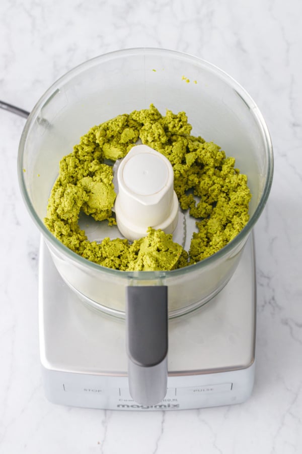 Part way through the process of making Homemade Pistachio Butter, the pistachios clump together into a green paste.