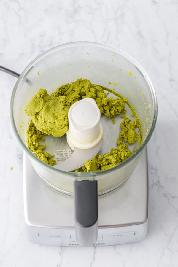 Part way through the process of making Homemade Pistachio Butter, the pistachios clump together into a green paste.