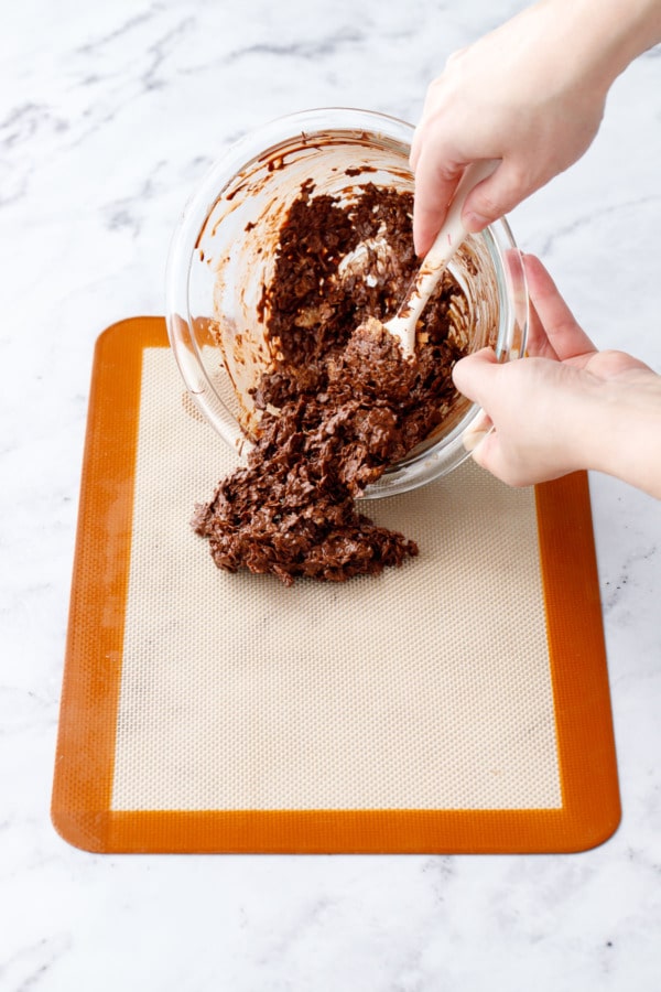 Pouring the croustillant mixture onto a silicone mat.