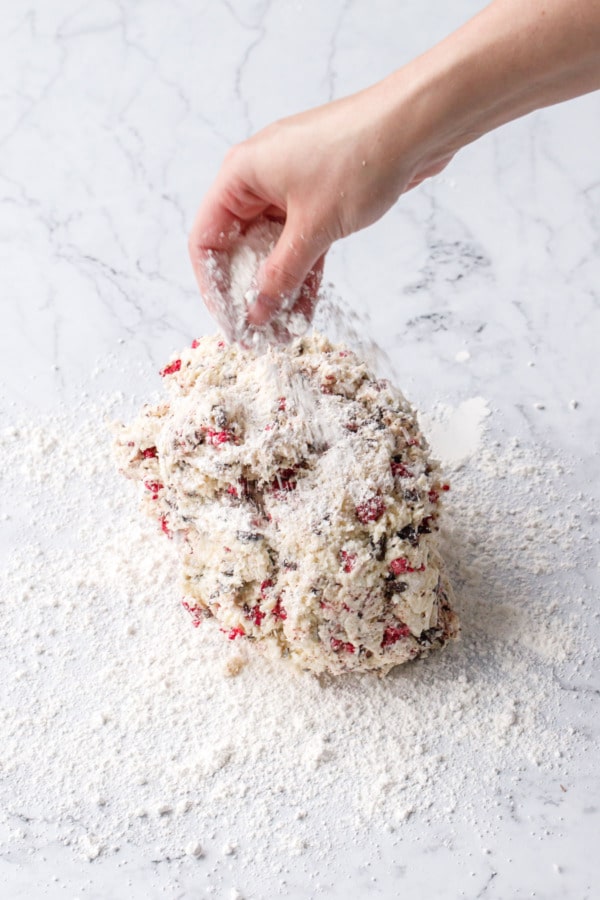 Dusting ball of scone dough with more flour.
