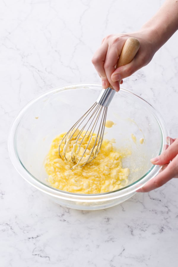 Whisk in an egg, the texture will appear slightly curdled at first.