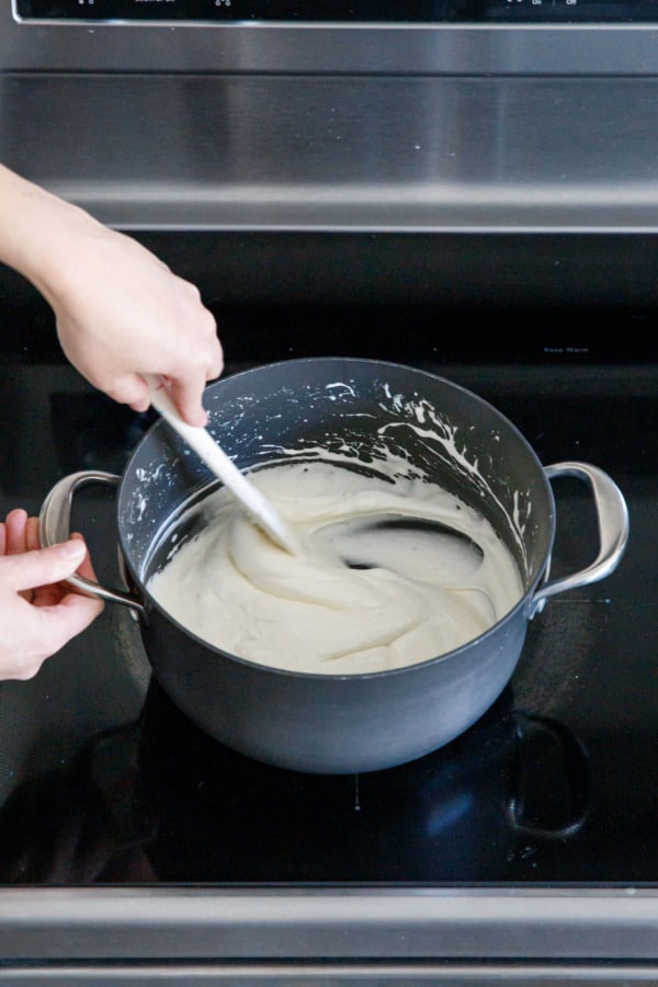 Melted mini marshmallows in a saucepan on the stovetop.