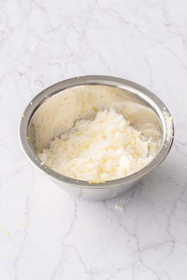 Small stainless bowl filled with lemon-rubbed sugar.