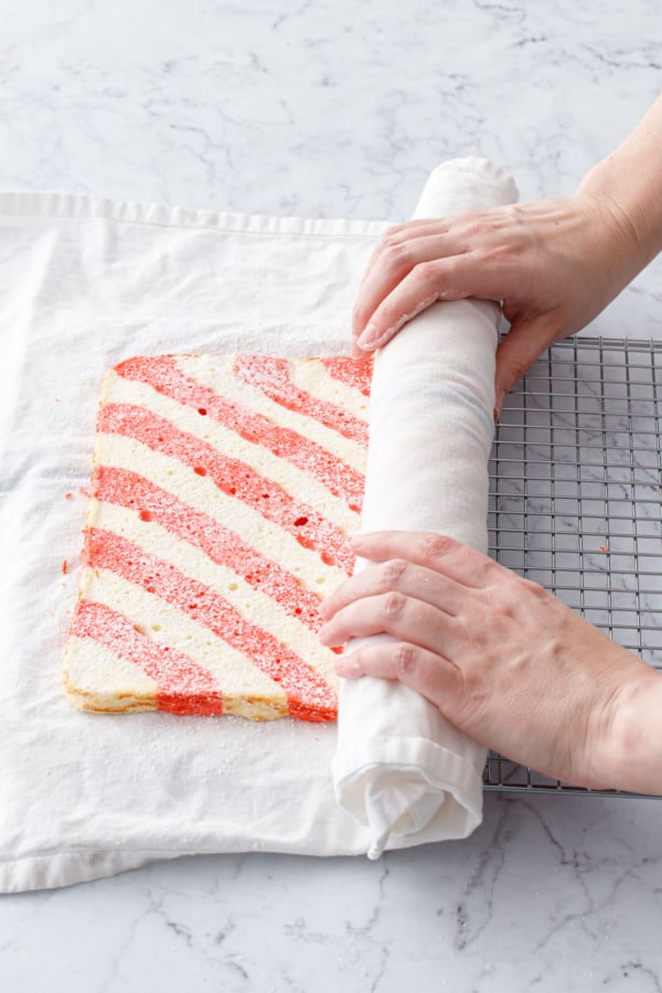 Rolling up the still-warm cake in the tea towel.