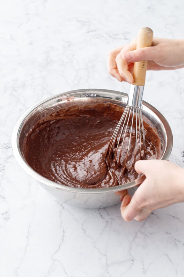 Whisking finished chocolate cupcake batter in a metal mixing bowl (the batter will still be slightly lumpy).