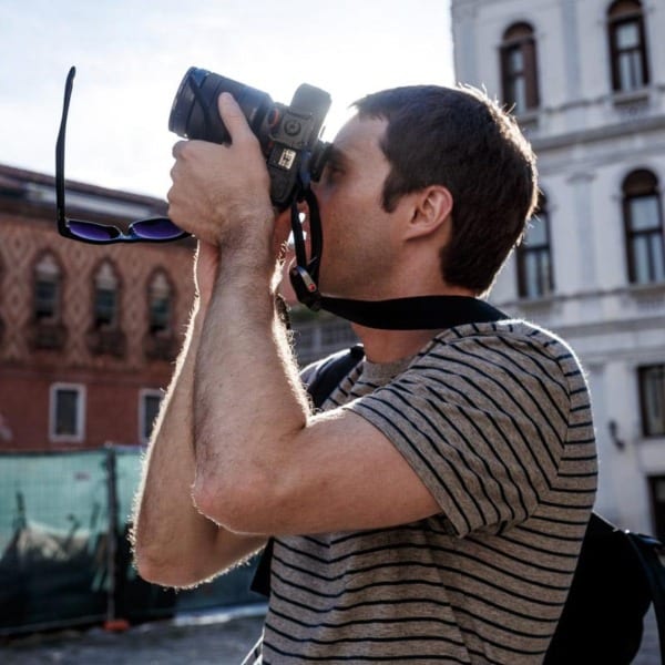 Taylor Headshot with a camera in Venice.