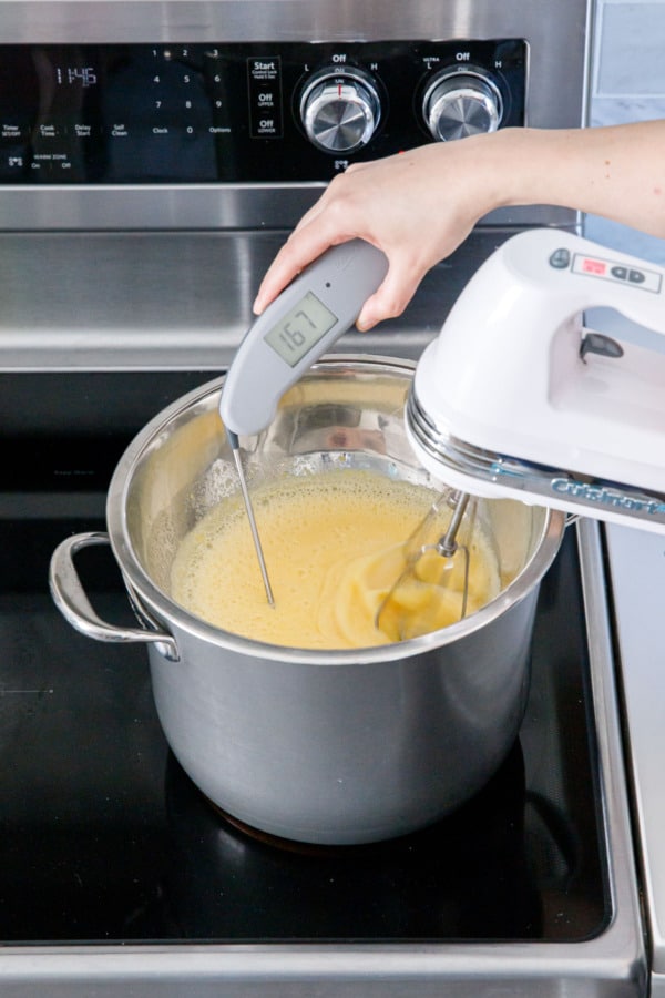 Taking the temperature of egg/sugar mixture that's been whipped overa a double boiler for 3 minutes.