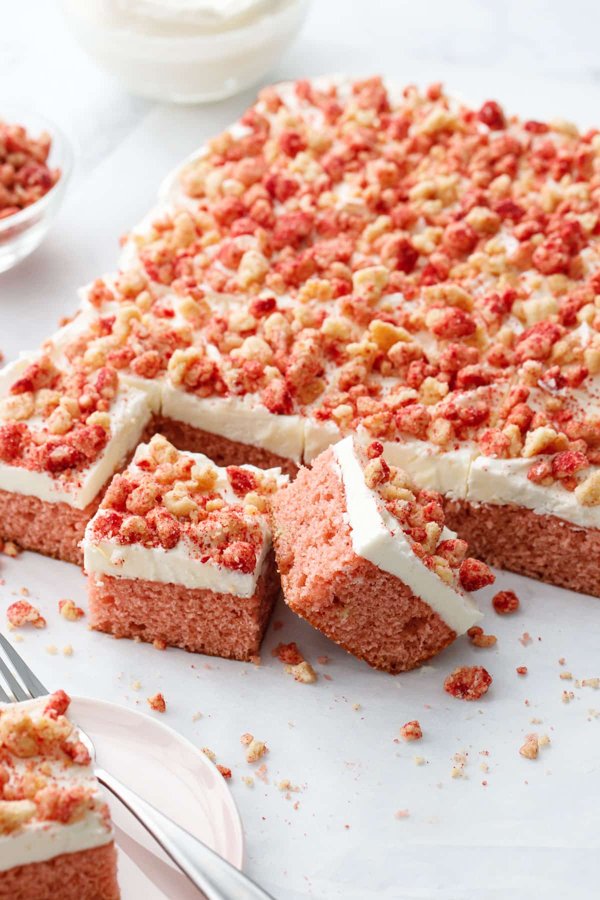 Strawberry Crunch Sheet Cake with Buttermilk Frosting, two cut squares in focus one leaning up against the other.