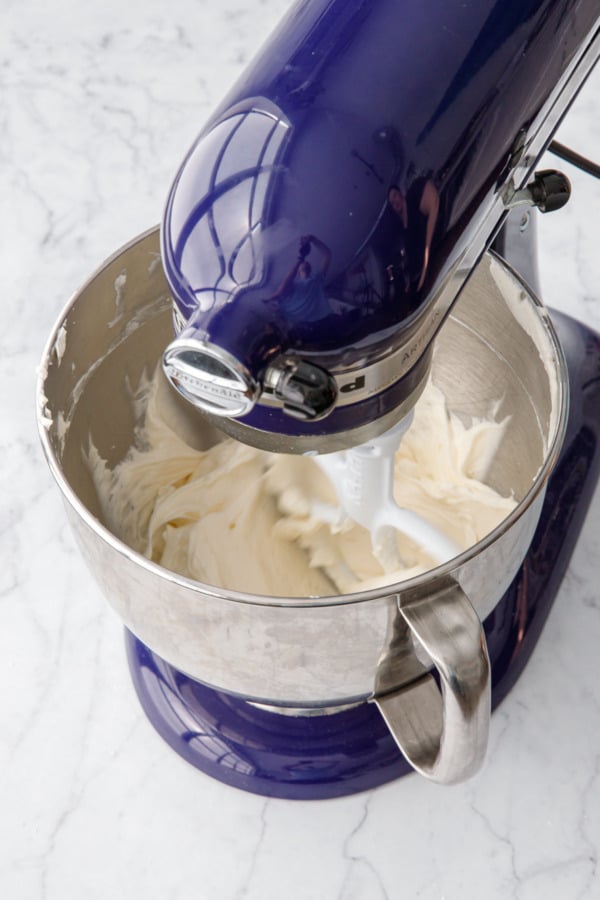 Mixer running and beating buttermilk buttercream until light and fluffy.