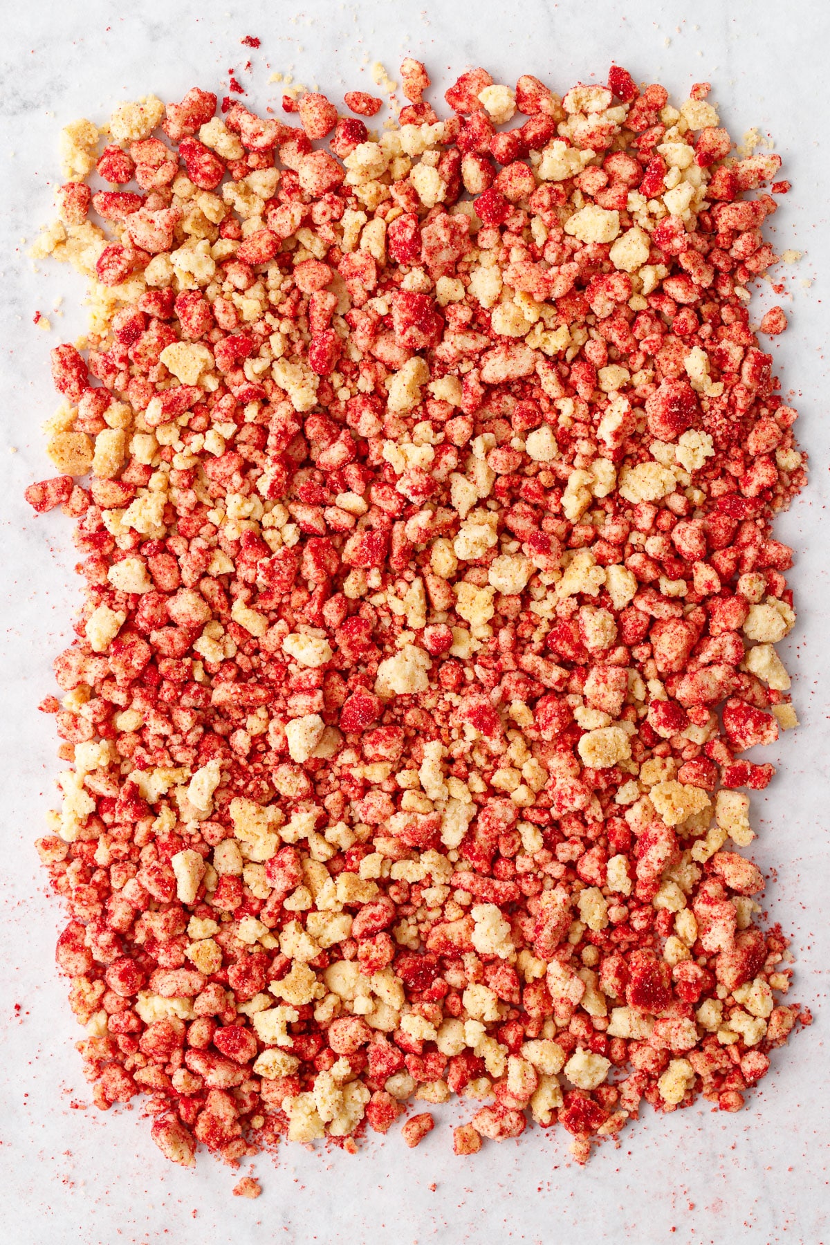 Overhead view of Strawberry Shortcake Crunch Topping, arranged in a rough rectangle on a marble background.