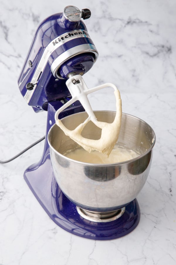 Mixer with paddle lifted to show the final consistency of the cake batter.