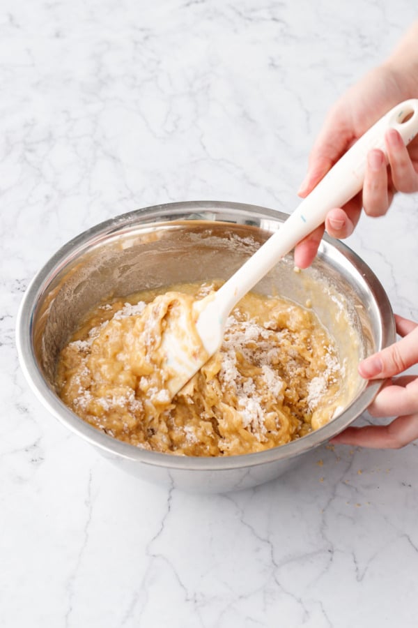 Folding the wet ingredients into the dry ingredients.