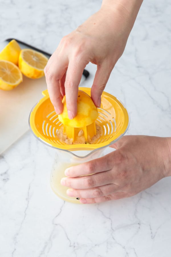 Juicing zested Meyer lemons.