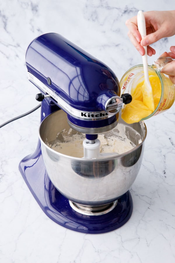 Adding lemon curd to the swiss meringue buttercream for flavor.
