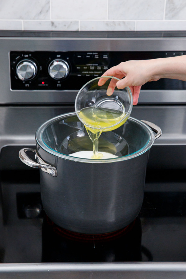Combining egg whites with sugar in the bowl of the double boiler.