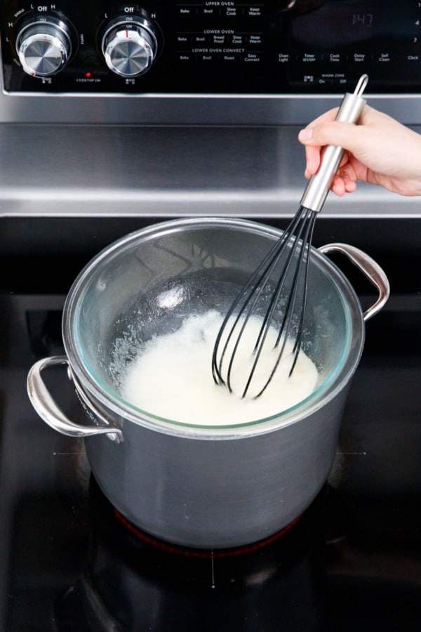 Whisking together egg whites and sugar in a double boiler, the texture will be thick and goopy to begin with.