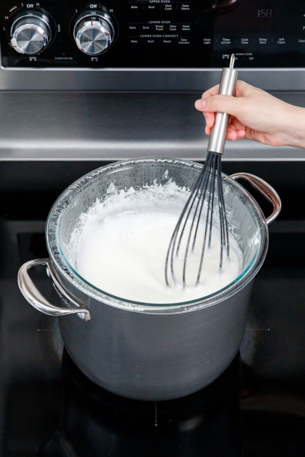 The appearance and texture of the meringue changes as it heats, lightening in color and increasing in volume.