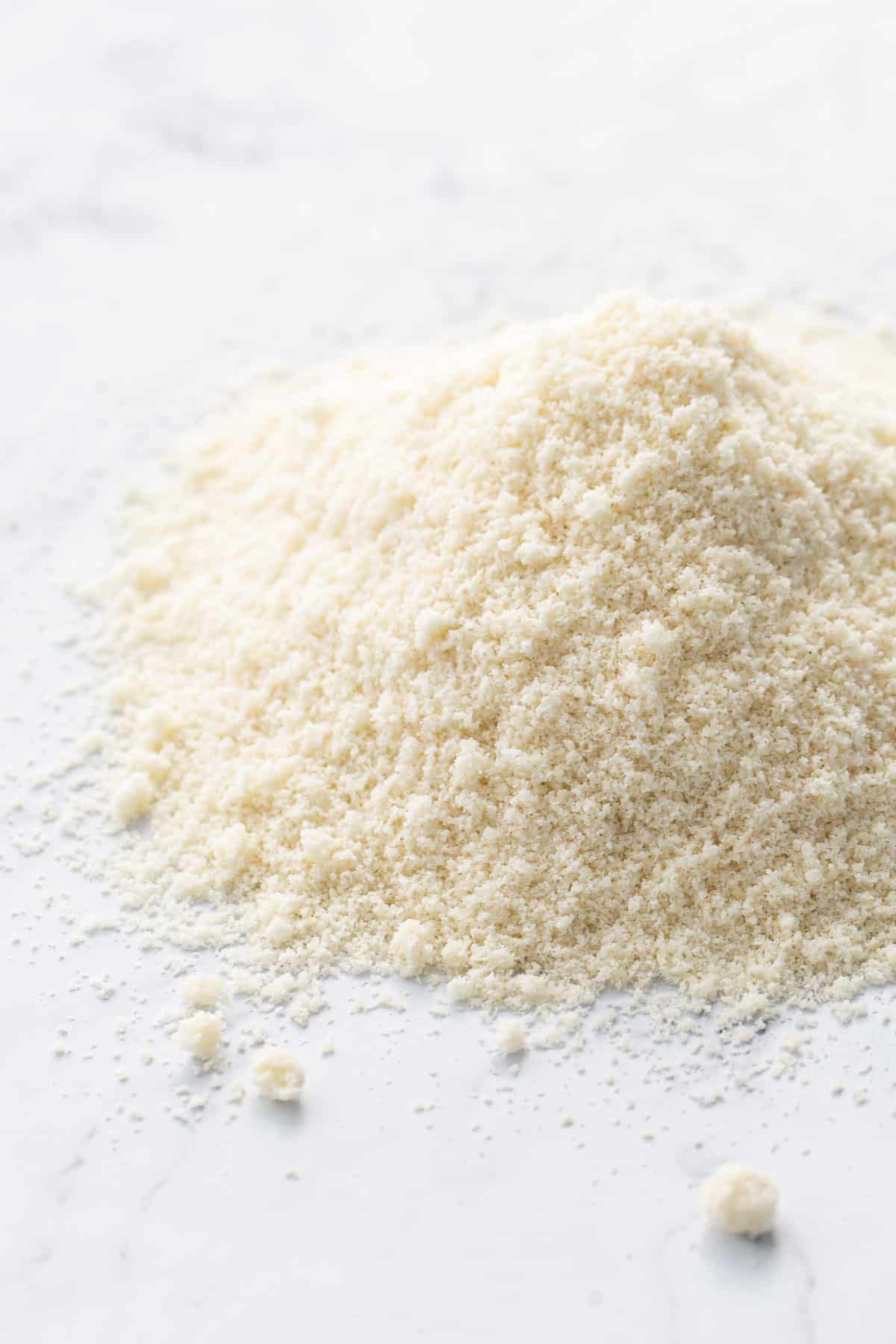 Pile of Homemade Blanched Almond Flour on a marble countertop.