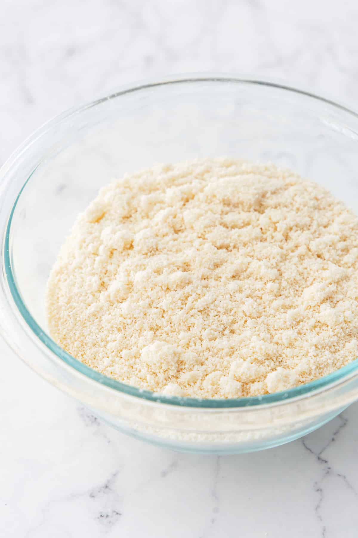 Glass bowl filled with Homemade Blanched Almond Flour.