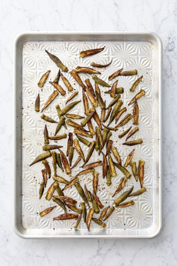 Okra on a baking sheet after baking.