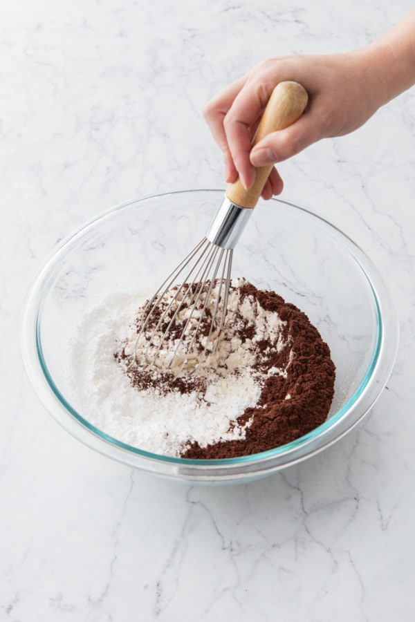 Whisking dry ingredients until evenly incorporated.