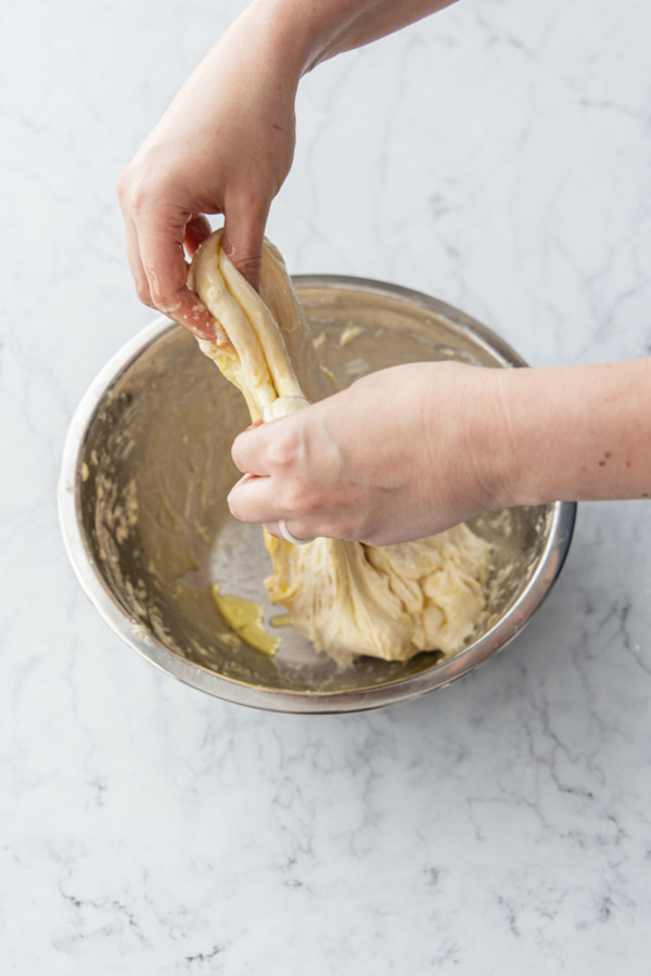 Pull and stretch the dough up from the top side of the bowl.